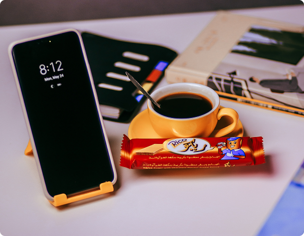 Workspace with phone, coffee and notebook